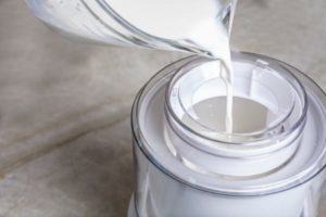 adding ingredients to ice cream maker