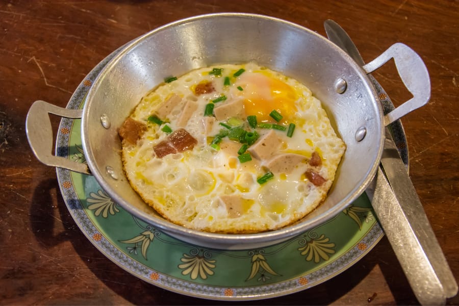 frying omelet in stainless steel cookware after preheating and applying extra oil