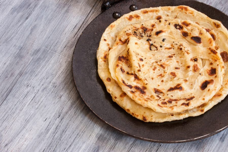 making chapati paratha in a roti tawa