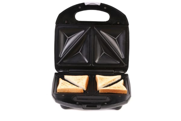placing the sandwich bread on the bottom plate while the top plate is still open